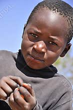Beautiful african boy holding candies