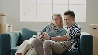 Wife and husband choose apartment furniture on telephone
