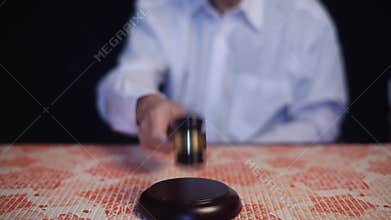 Judge hitting gavel off a block in courtroom