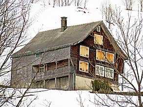 Old traditional swiss rural architecture and alpine livestock farms in the winter ambience of the region over the Lake Walen