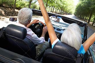 Senior couple in sports car