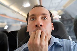 Man Having Anxiety Attack In Airplane