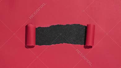Red paper opening ripping to reveal black copy space