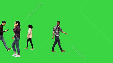 People walking in the streets, passing by Urban life concept on a Green Screen, Chroma Key.