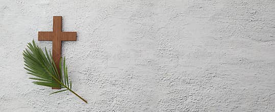 Palm sunday background. Cross and palm on grey background.
