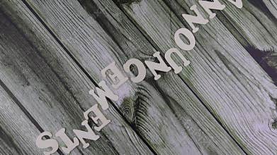 Announcements concept on wooden background viewed as a flat lay still life