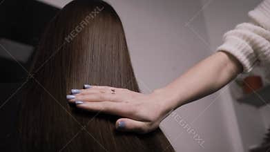 Demonstration of smooth and silky hair after straightening it with a steam pod