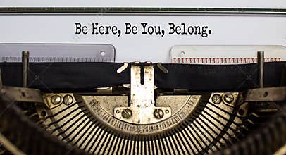 Inclusion and belonging symbol. Words `be here, be you, belong` typed on retro typewriter. Business, inclusion, belonging and yo