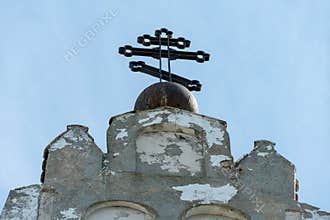 Orthodox cross on top of an old against a clear sky on a summer day. The cross as a symbol of faith in God