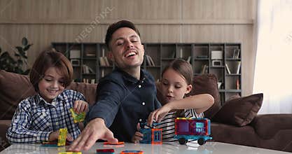 Father and children build creative vehicle play together magnetic constructor