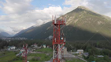 Mobile telecommunication tower in the small town between mountains