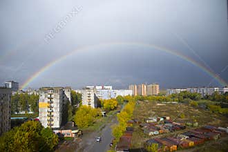 Big beautiful rainbow above the ugly city