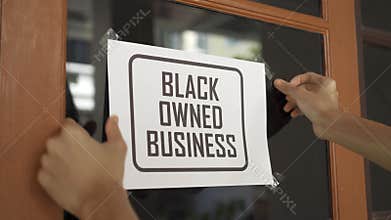 Black owned business sign were attached on the window