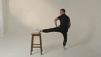 Dynamic and highly innovative dance pose positioned on a stool for engaging creative performances