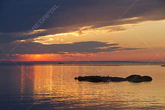 Sunset sky over Ladoga Lake with silhouettes