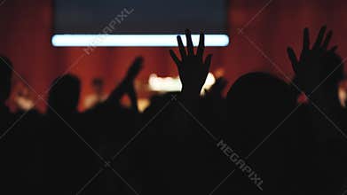 Christians raising their arms in praise, passionate church service and prayer