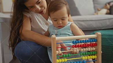 Mother and toddler using abacus in the living room with love and care