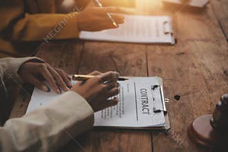 Business and lawyers discussing contract papers with brass scale on desk in office. Law, legal services, advice, justice and law