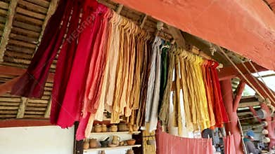 Set of fabrics colored with natural pigment powder made from herbs and flowers hanging to dry.
