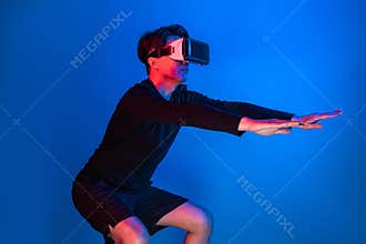 Smart sportman player wearing VR stretching whole body posing. Contrivance.