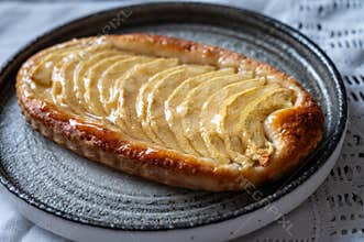 French fresh baked sweet puff pastry with fresh apple fruits in sirup in confectionery shop