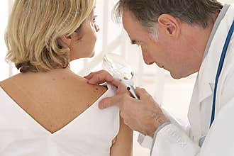 Doctor and patient - - looking for skin disease