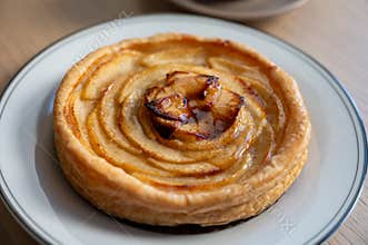 French fresh baked sweet puff pastry with fresh apple fruits in sirup in confectionery shop