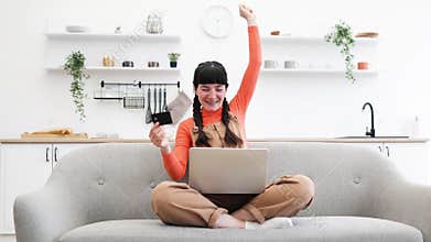 Young woman shopping online with credit card and laptop