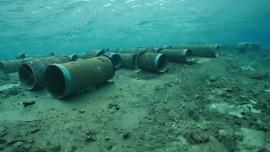 Rusty barrels on the ocean floor. Pollution of the world's oceans with chemical waste.