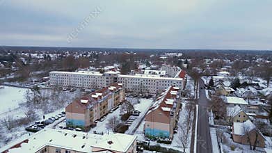 Winter Village Snow houses road, cloudy sky. Magic aerial top view flight drone