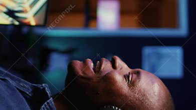 Vertical video Man doing podcasting session with professional streaming sound gear, panning shot