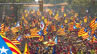 Crowd of People with Catalan Flags on the Street