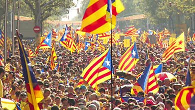 Crowd of People with Catalan Flags on the Street