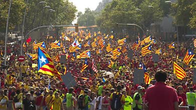 Crowd of People with Catalan Flags on the Street