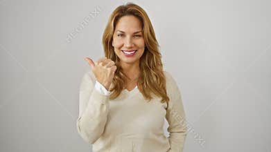 Stunning young latin woman, with a megawatt smile, happily points to the side with a thumbs up on a crisp white background. this