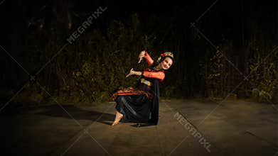 a Balinese dancer looks graceful when moving his hands and feet on stage very agilely