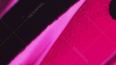 Vertical abstract background glitter ink flow pink black