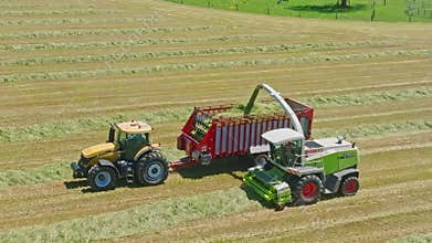 Harvest Dance: Tractors Bale Hay in Golden Fields with azure skies