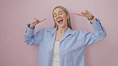 Joyful young blonde woman pointing at her perfect teeth, showing off a cheerful smile. dental health extraordinaire, standing