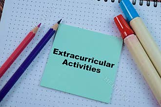 Concept of Extracurricular Activities write on sticky notes isolated on Wooden Table