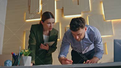 Two architects working draft at building company office close up. Engineers plan