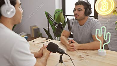 Two men podcasting in a modern studio with microphones and neon decoration, showcasing cryptocurrency interest