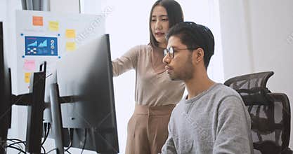 Software developer coding program on desktop computer. Man, woman work from home, remote working