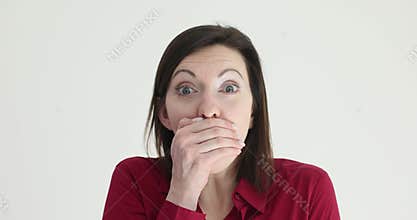 Lady employee places palm on mouth showing surprise