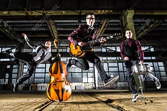 Rock band jumps into the air in an industrial building