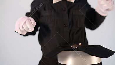 Little boy magician with tie and kitten in hat on