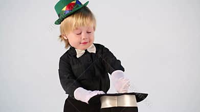 Little magician in a green hat waved his wand over