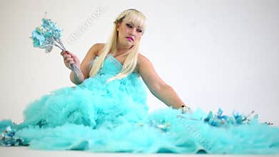 Beautiful woman in a blue dress collects flowers