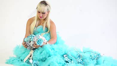 Beautiful woman in blue is holding a bouquet of