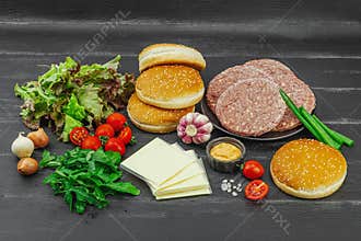 Burger patties. Beef cutlets, buns, vegetables and sauce. Homemade American classic